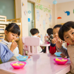 Image of children looking quizically at the photogrpher. Photo by Naomi Shi: https://www.pexels.com/photo/three-toddler-eating-on-white-table-1001914/
